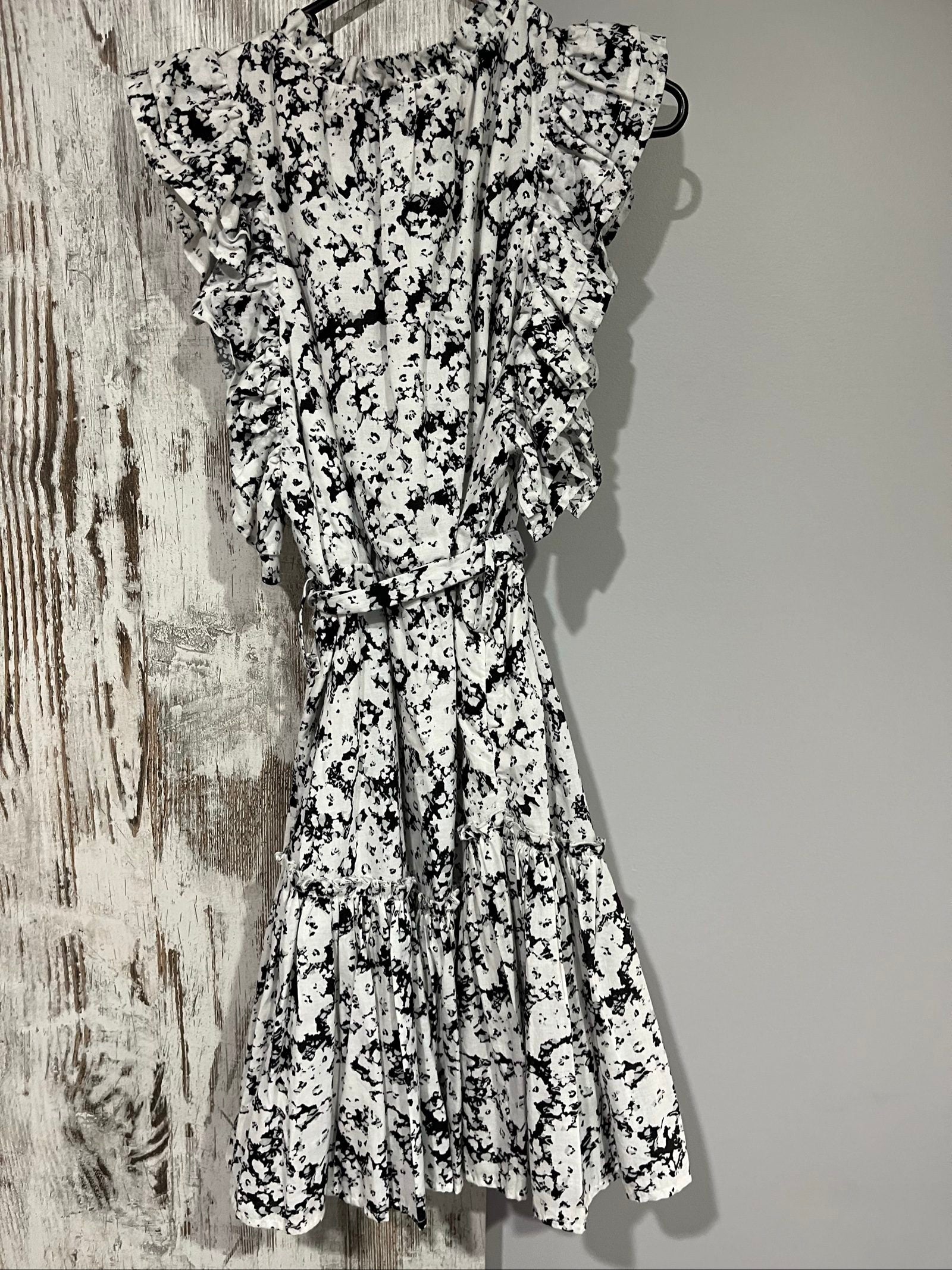 Aureta mini dress black and white abstract floral print with ruffle sleeves and buttons.