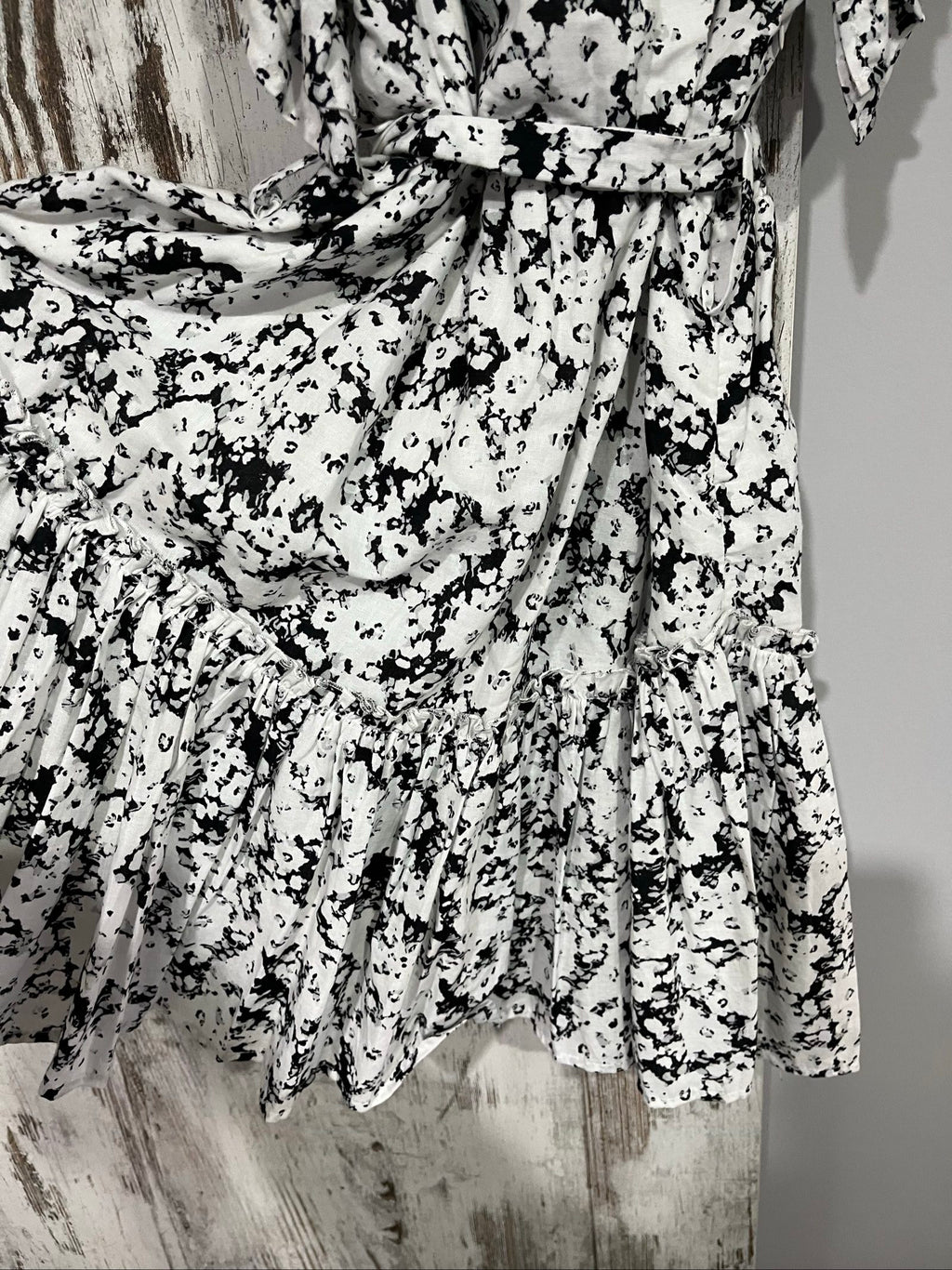 Aureta mini dress black and white abstract floral print with ruffle sleeves and buttons.