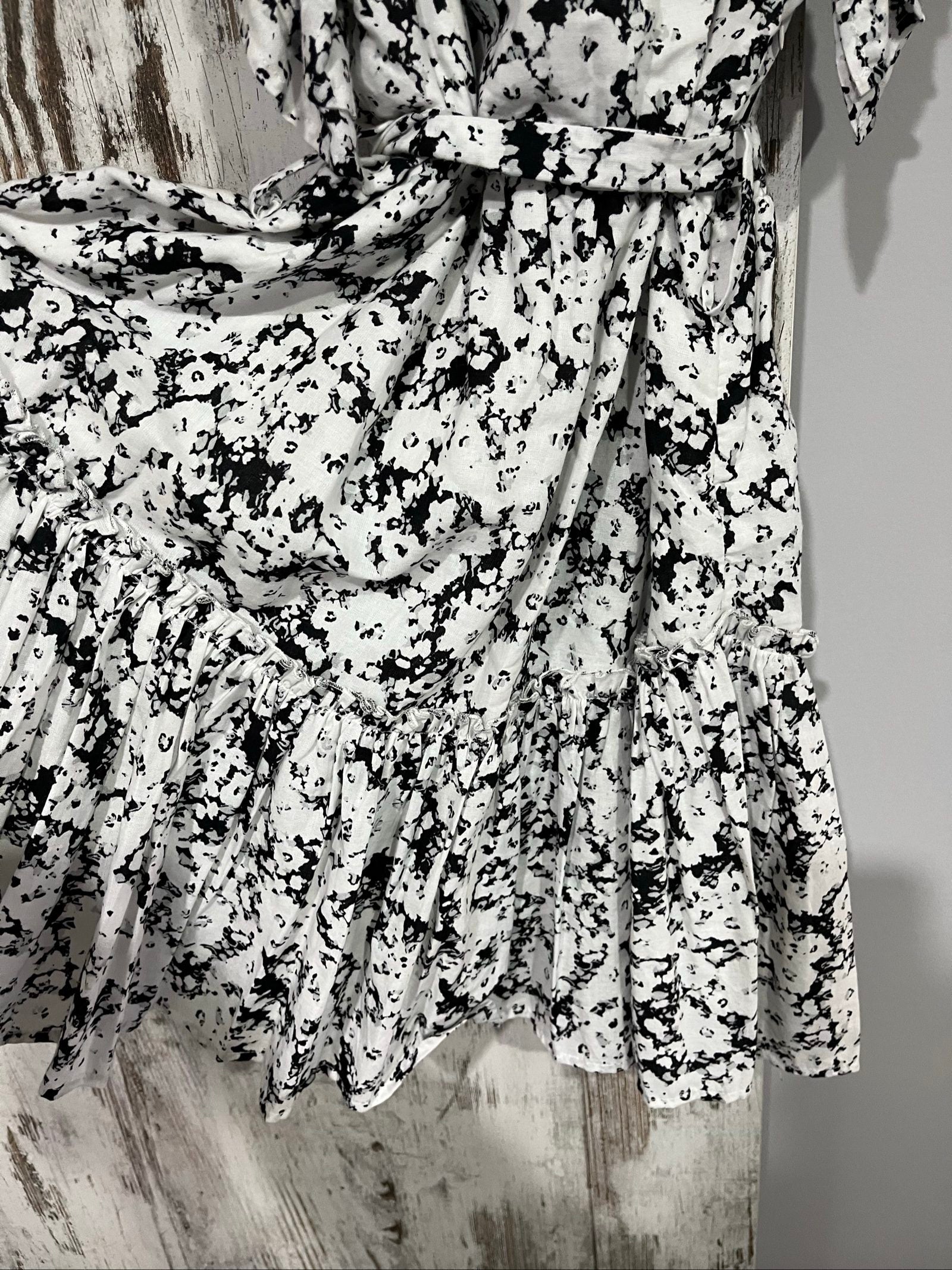 Aureta mini dress black and white abstract floral print with ruffle sleeves and buttons.
