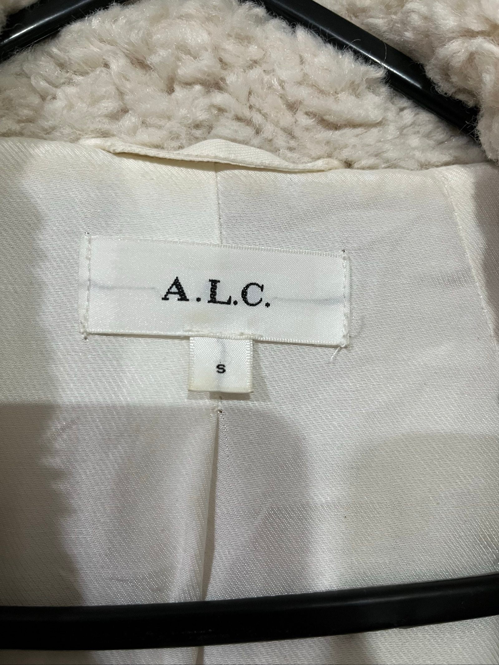 ALC beige faux shearling coat with wide collar and soft plush texture.