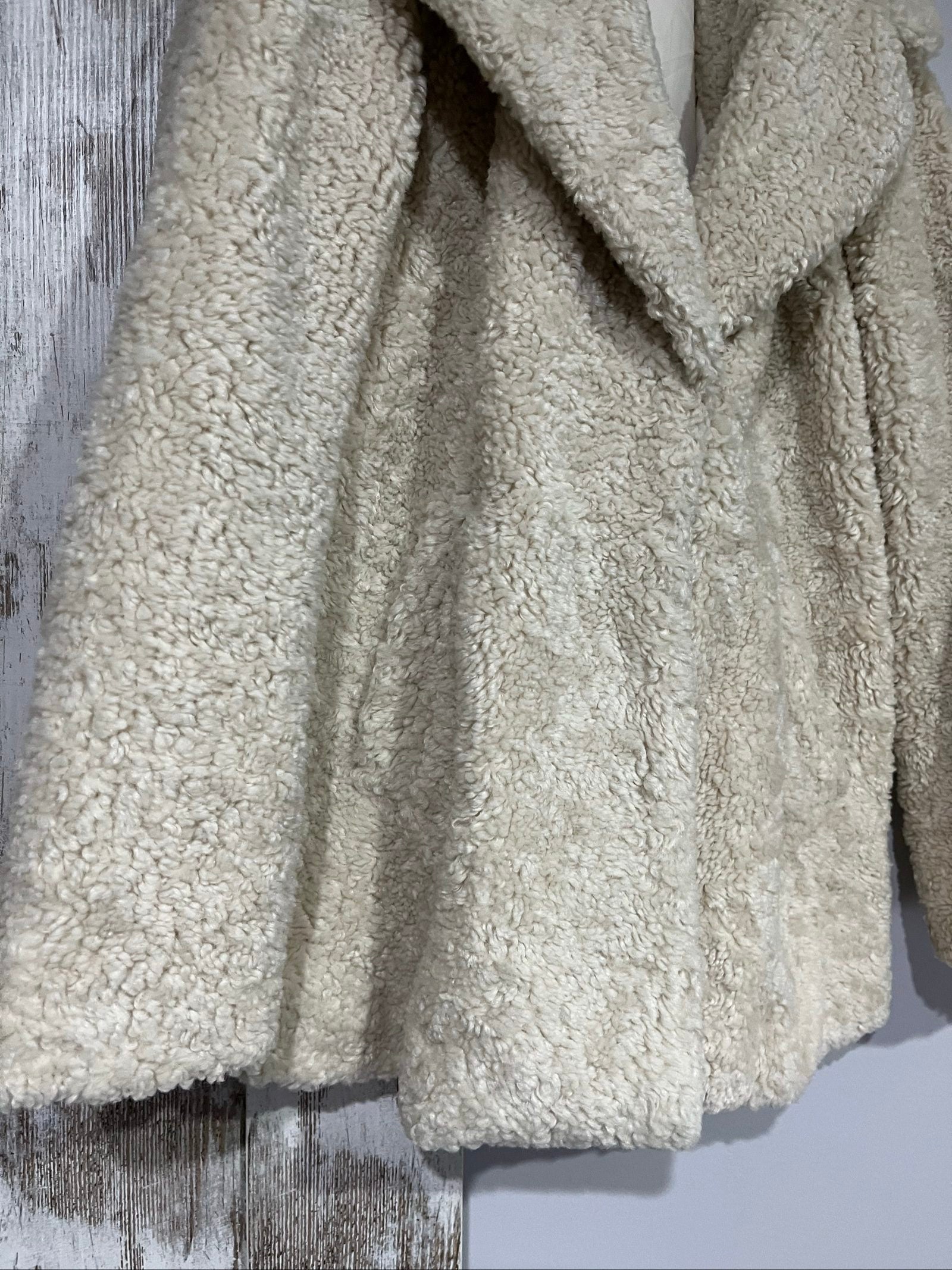 ALC beige faux shearling coat with wide collar and soft plush texture.