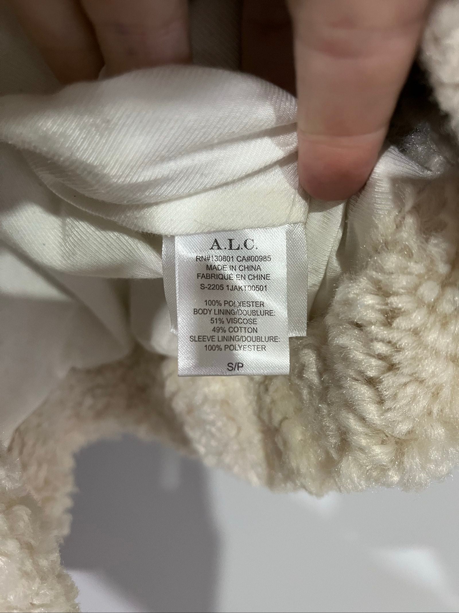 ALC beige faux shearling coat with wide collar and soft plush texture.