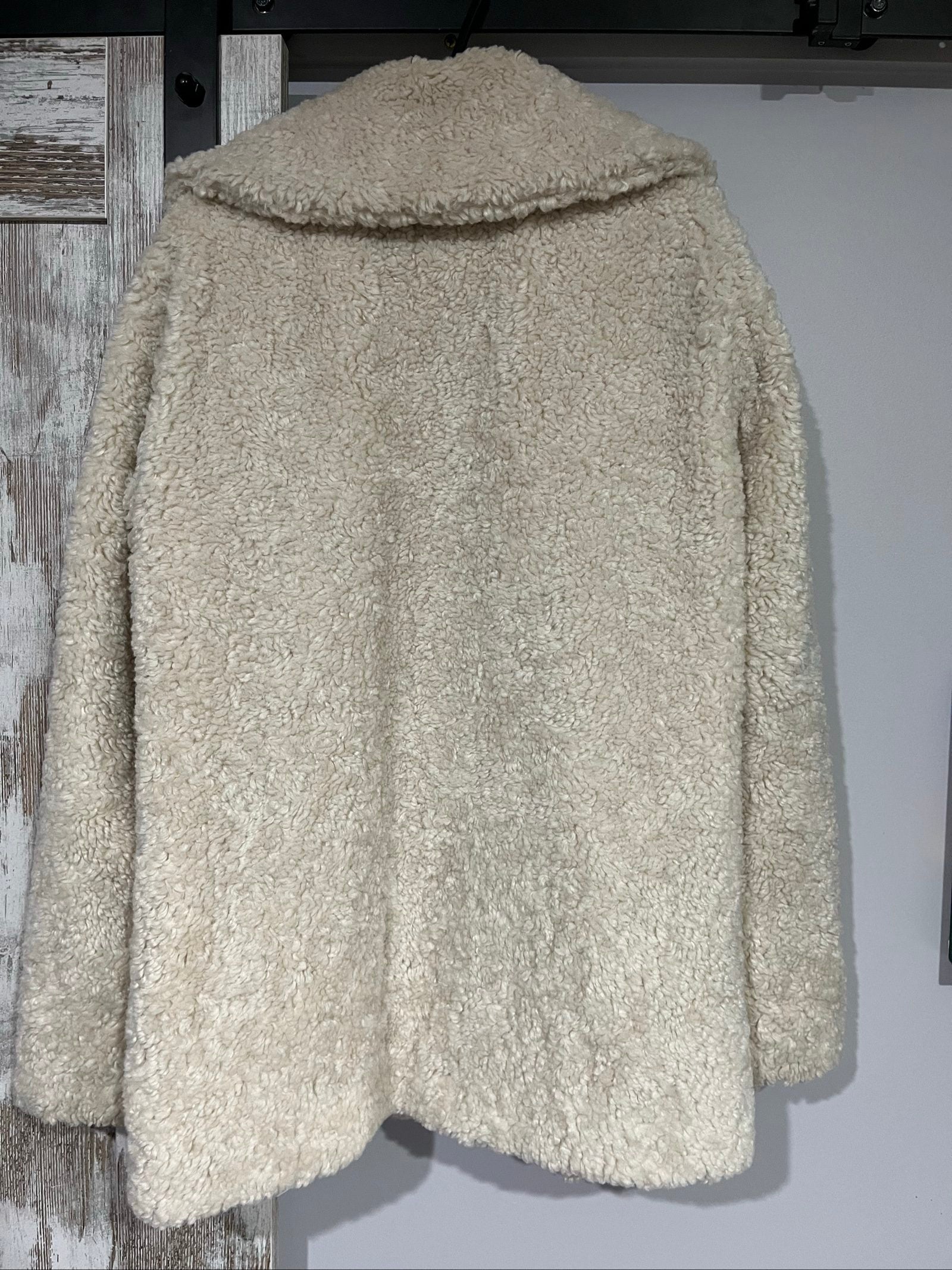 ALC beige faux shearling coat with wide collar and soft plush texture.