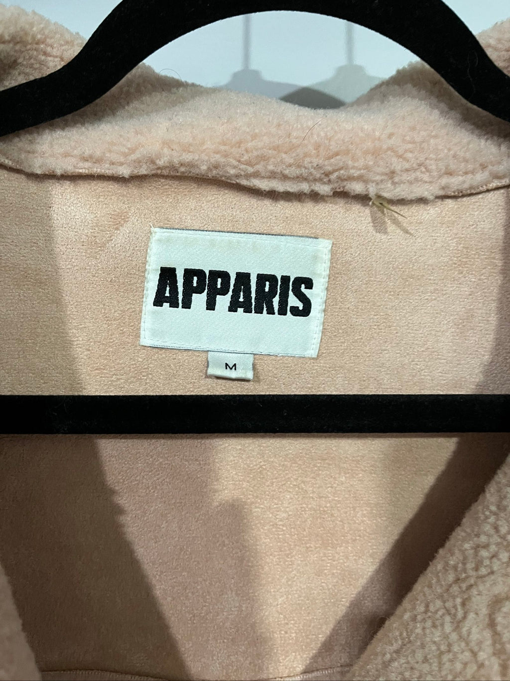 APPARIS beige biker jacket with faux shearling lining, zip-up front, and silver-tone hardware.