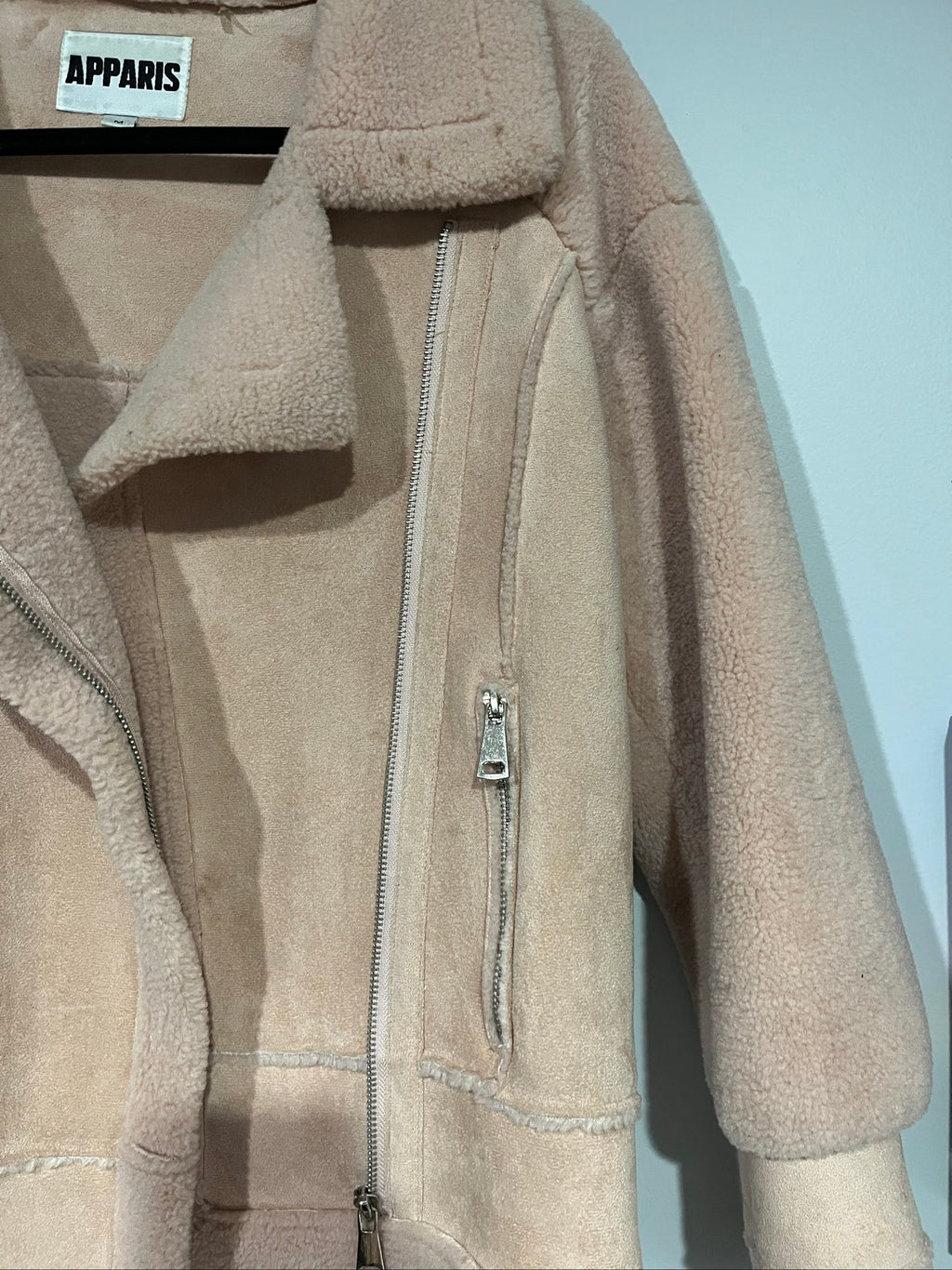 APPARIS beige biker jacket with faux shearling lining, zip-up front, and silver-tone hardware.