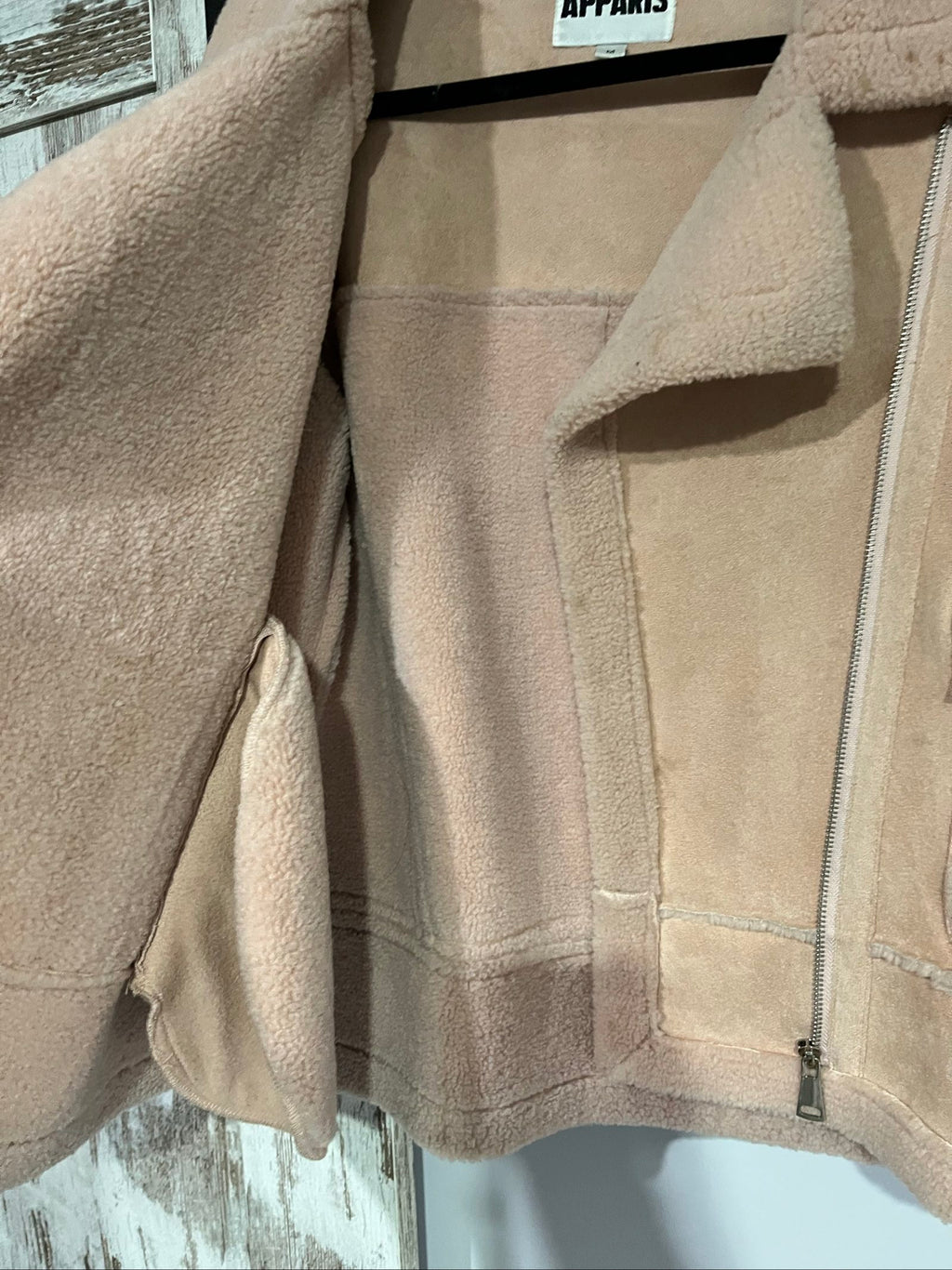APPARIS beige biker jacket with faux shearling lining, zip-up front, and silver-tone hardware.