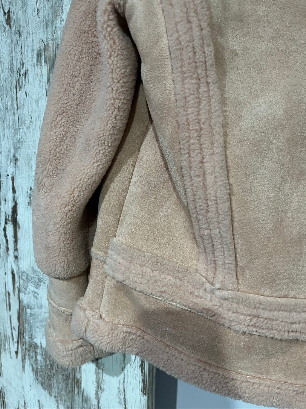 APPARIS beige biker jacket with faux shearling lining, zip-up front, and silver-tone hardware.