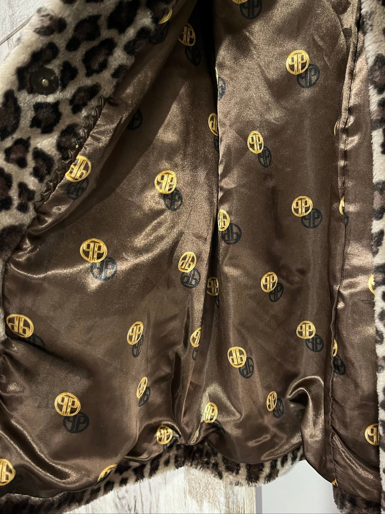 Dennis Basso beige leopard print faux fur coat with wide collar and satin logo lining.