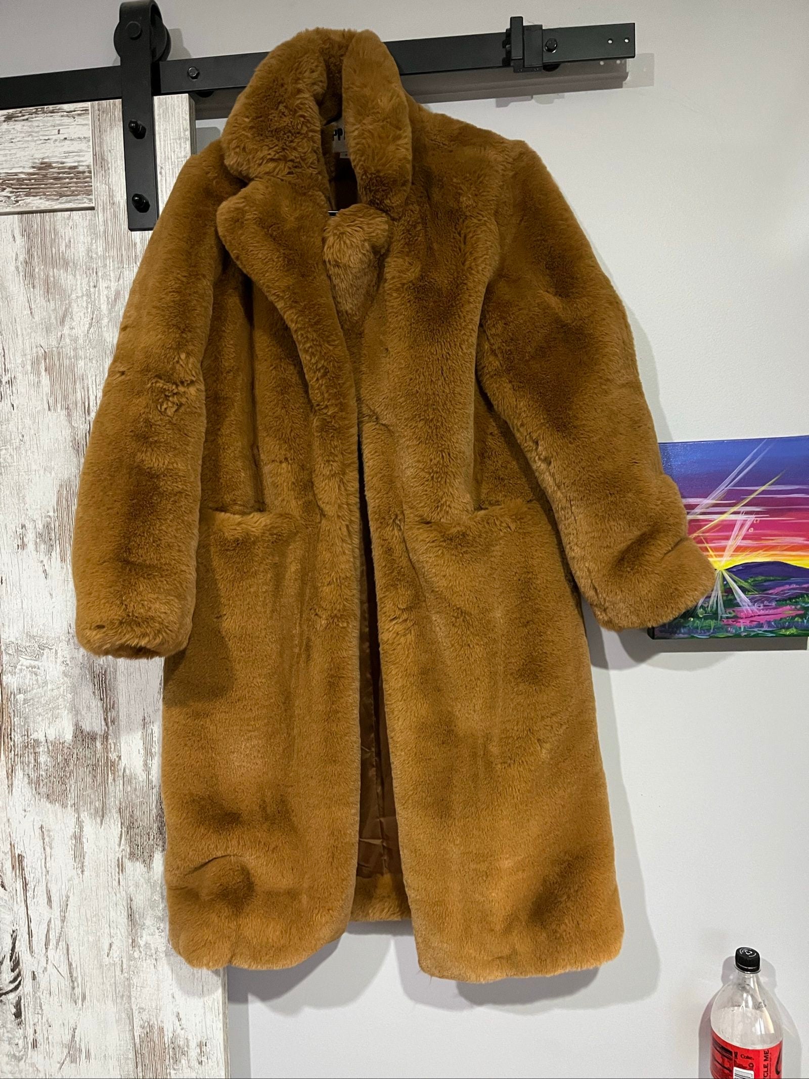 APPARIS brown faux fur coat with large lapels, plush texture, and two front pockets.