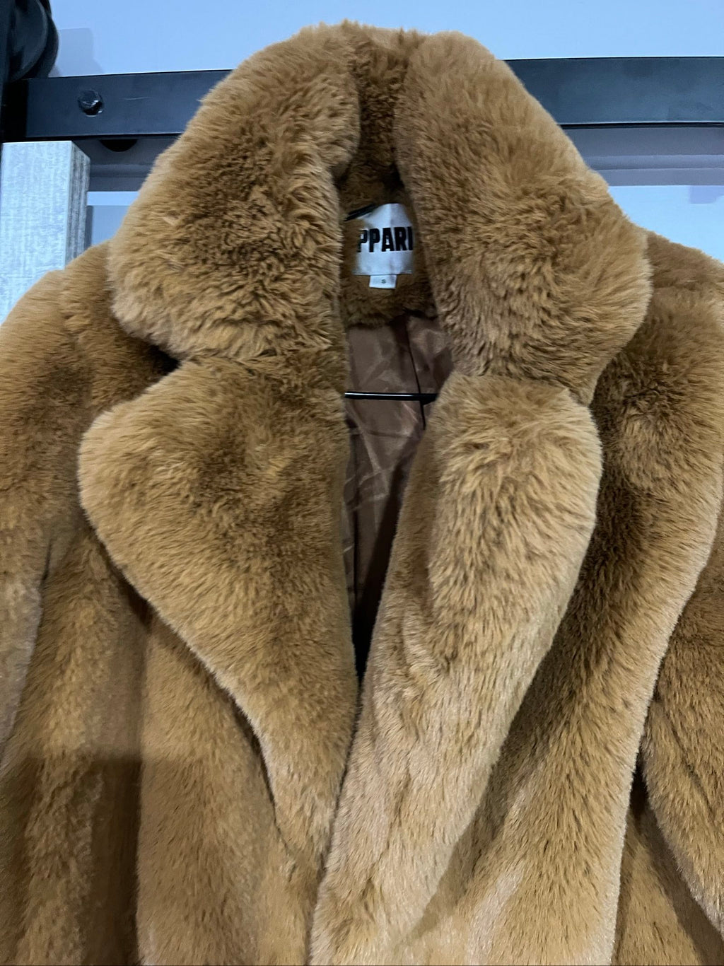 APPARIS brown faux fur coat with large lapels, plush texture, and two front pockets.