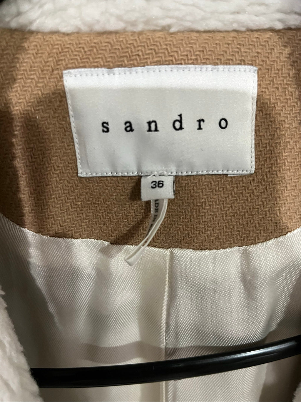 Sandro camel coat with white faux shearling collar and silver-tone zipper pockets.
