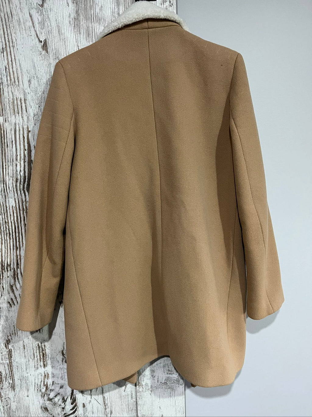 Sandro camel coat with white faux shearling collar and silver-tone zipper pockets.