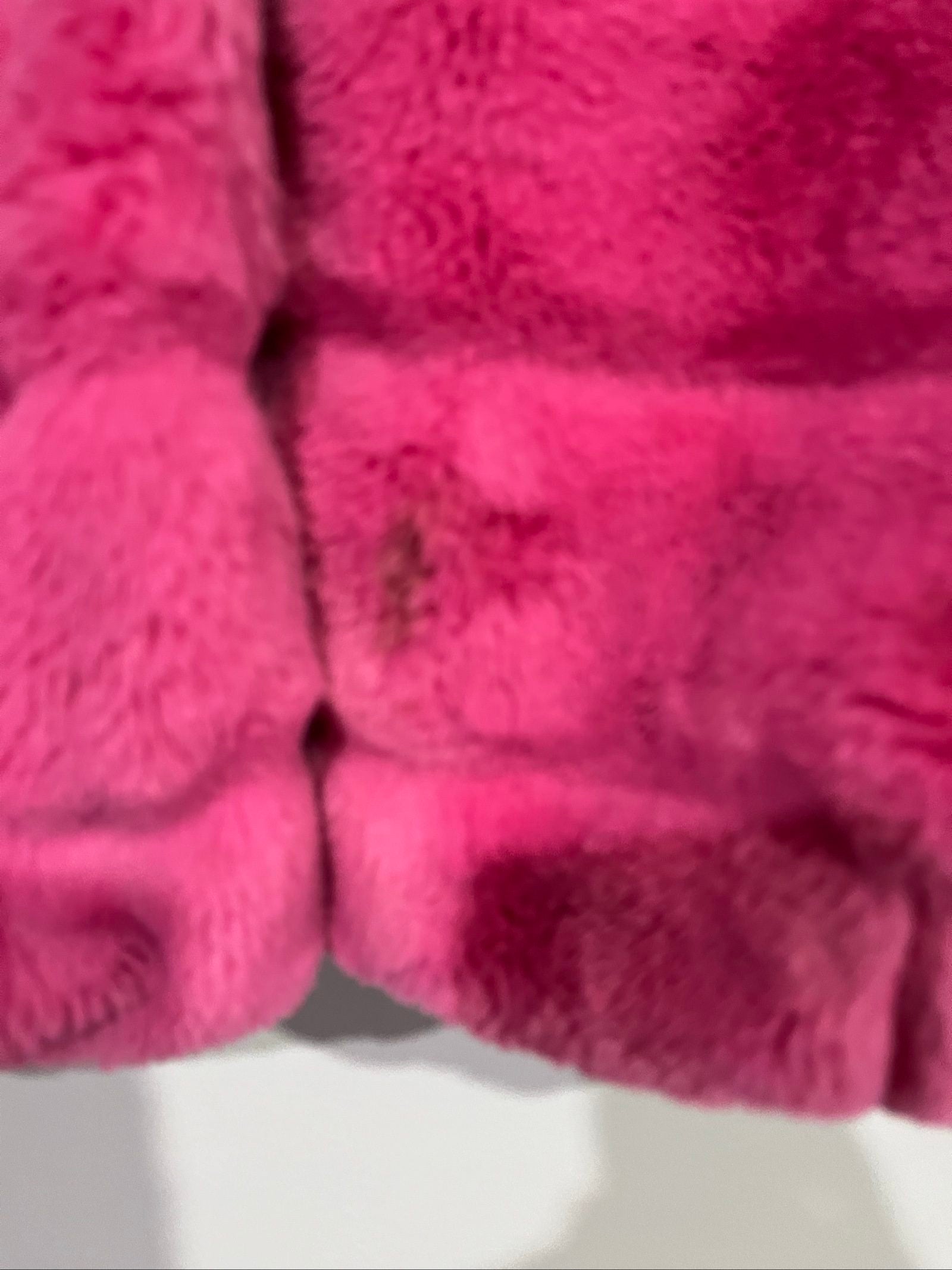 Apparis pink faux fur hooded jacket with snap-button closures and plush texture.
