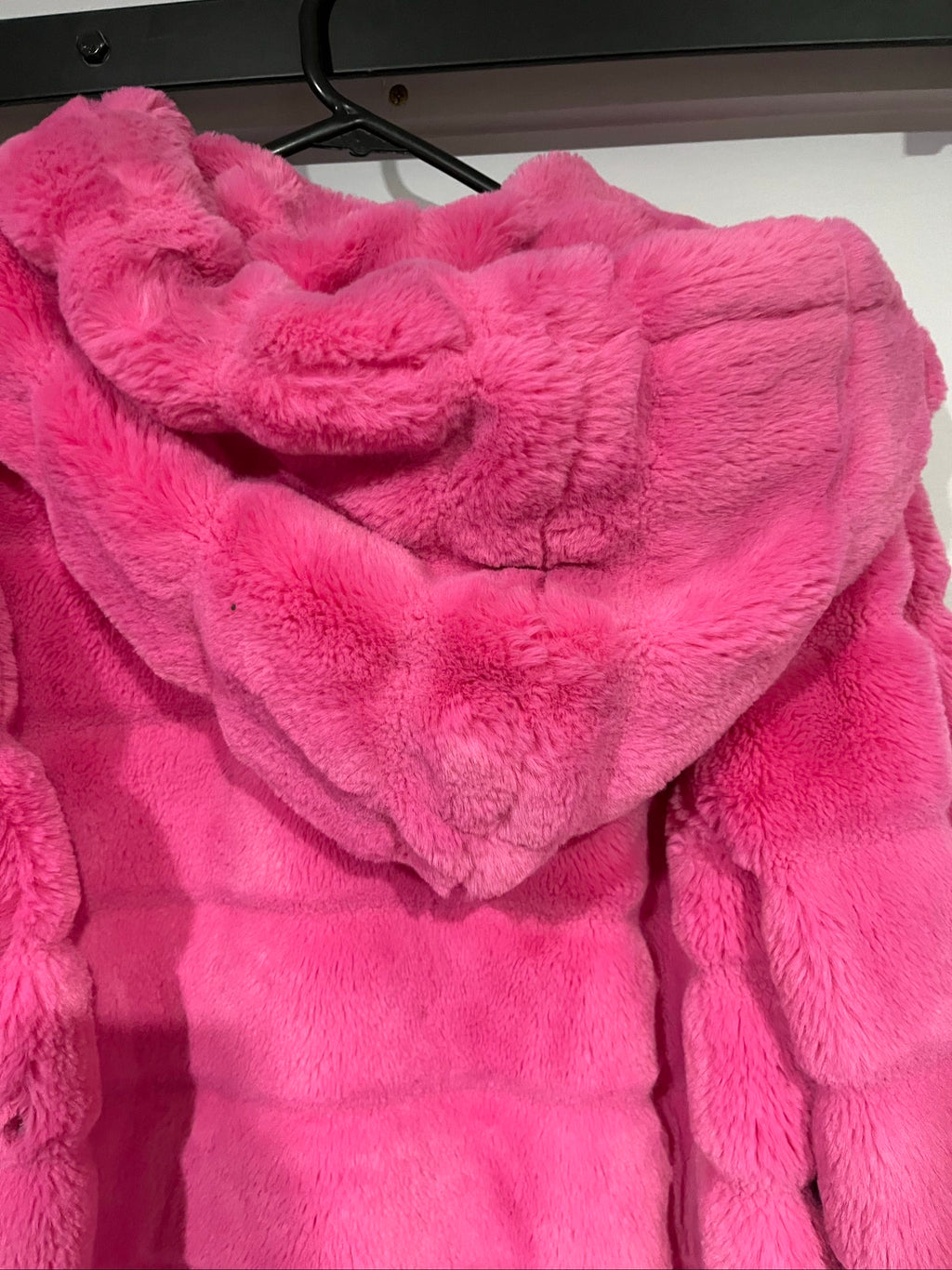 Apparis pink faux fur hooded jacket with snap-button closures and plush texture.